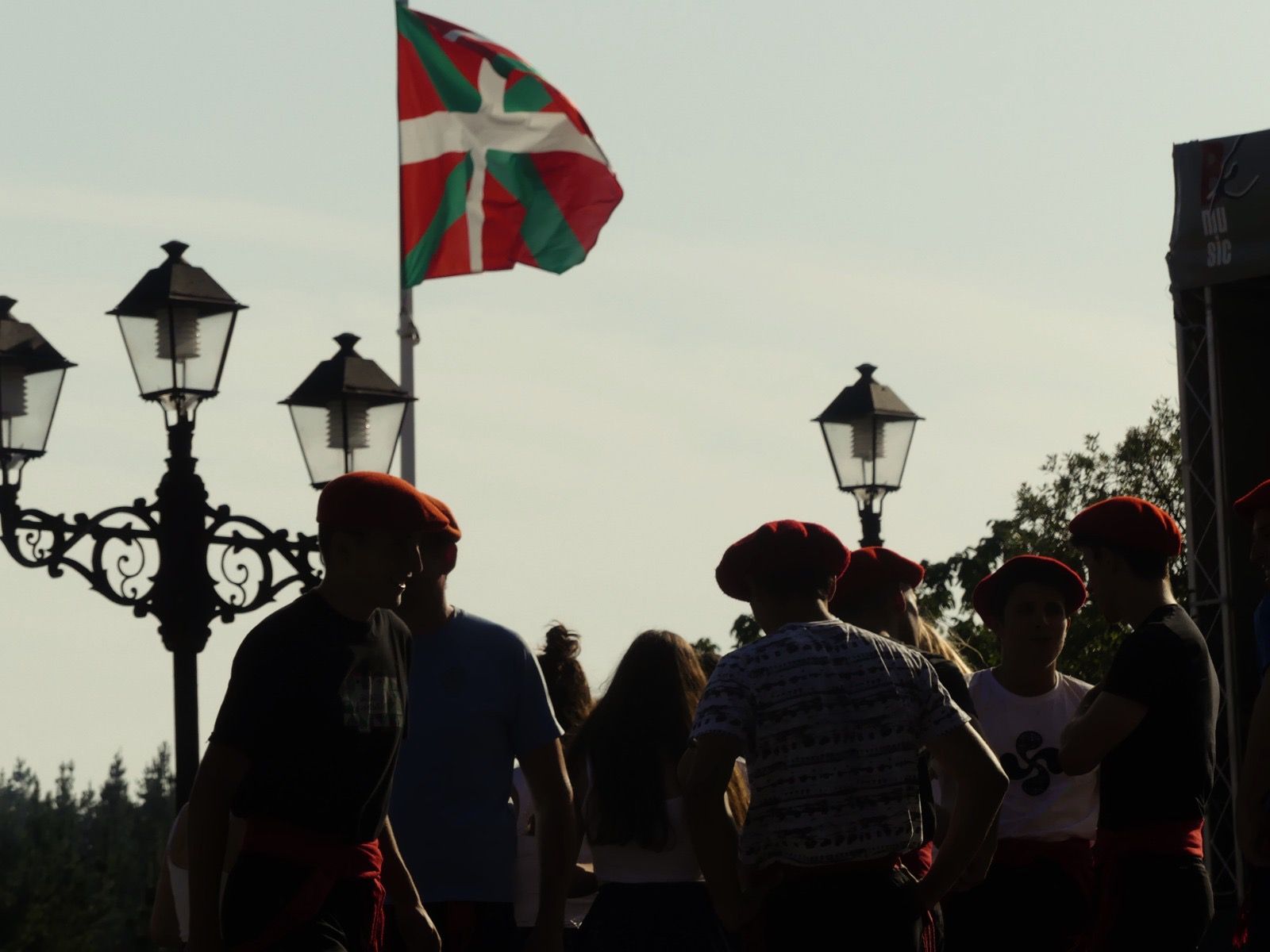 Basque flag and red berets at a local festival.